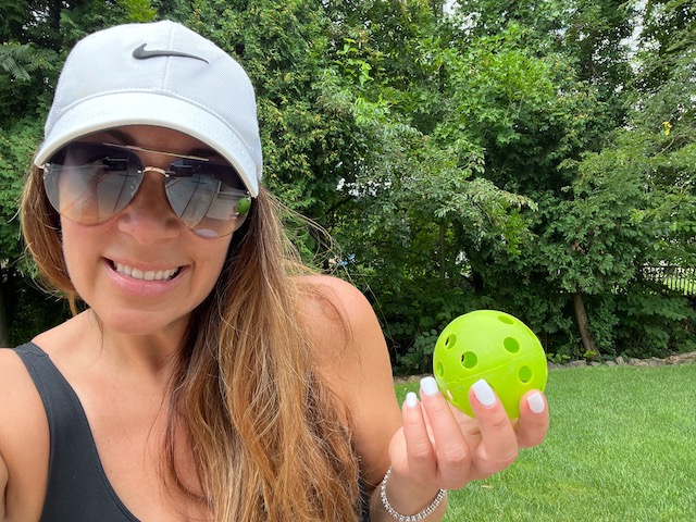woman holding best pickleball for outdoor play. best outdoor pickleballs. Happy People Pickleball LLC